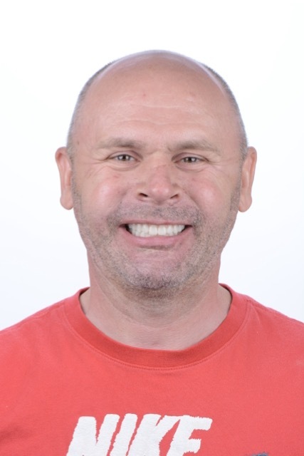 Male patient smiling after full-arch restoration