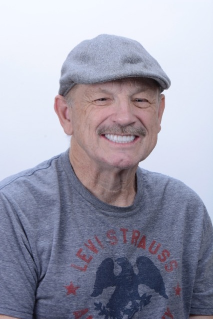 Male patient smiling after full-arch restoration